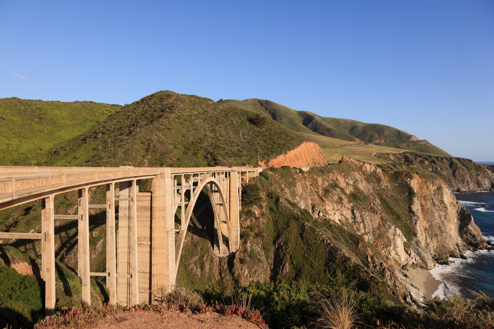 Bixby Creek Bridge arches over its canyon on the Big Sur coast along Highway 1. Fire crews worked both fires through September.