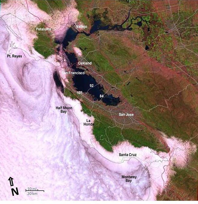 A Landsat satellite view of the marine layer over the Bay Area and Monterey Bay. The coast gets the cooling fog; the heat advisory covers the county's interior valleys.