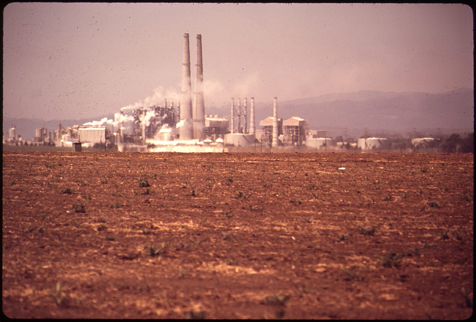 The Moss Landing Power Plant's twin stacks rise beyond tilled farmland in this May 1972 photograph of the area. Deputies found the infant authorities call Baby Angelita on Aug. 1 near an agricultural field on the 100 block of Struve Road in Moss Landing.