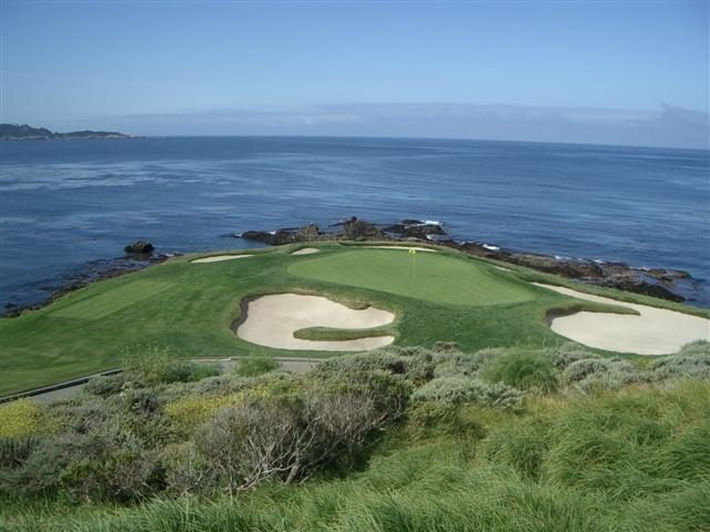 The short par-3 7th hole at Pebble Beach Golf Links plays toward the Pacific. Golf tourism is a pillar of the Peninsula's high-end visitor economy.